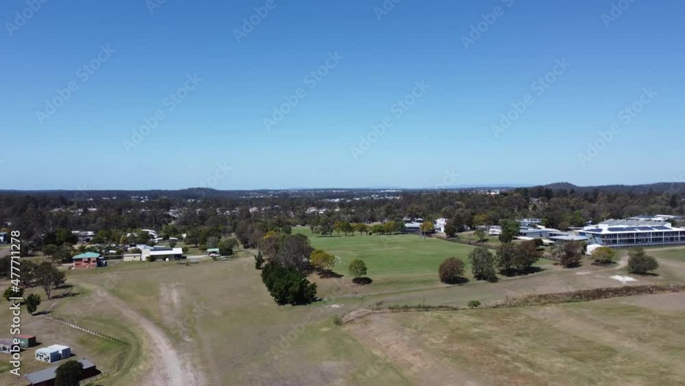 Aerial view of an Australian green park flying towards the football fields Aerial view of an Australian green park flying towards the football fields
