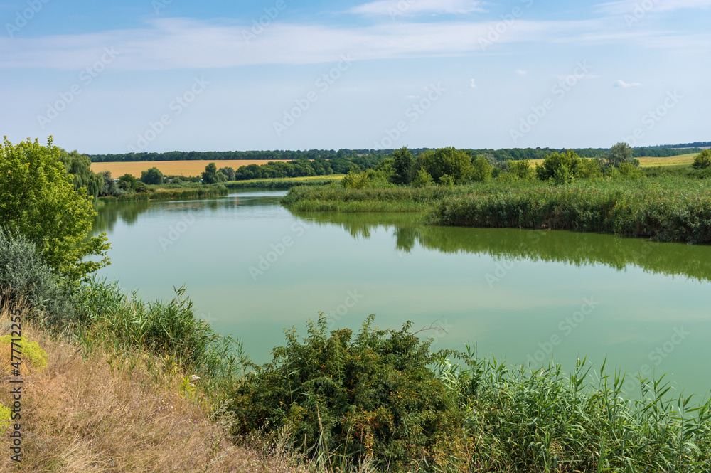 Ukrainian rural landscape with small river Sura at late summer season