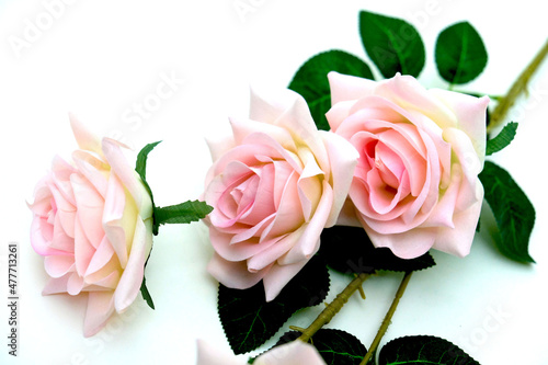 Bouquet of artificial pink roses on white background