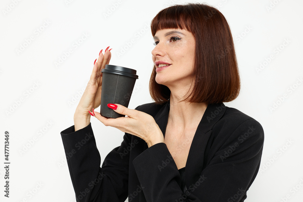 photo pretty woman in a suit glass of coffee posing isolated background photo pretty woman in a suit glass of coffee posing isolated background