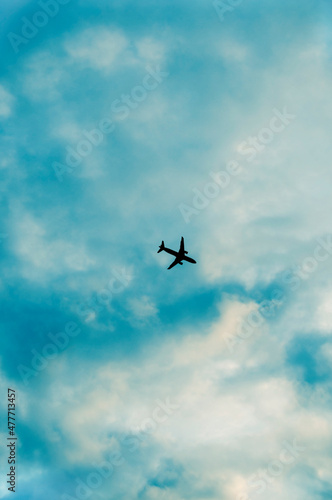 silhouette of an airplane high in the sky
