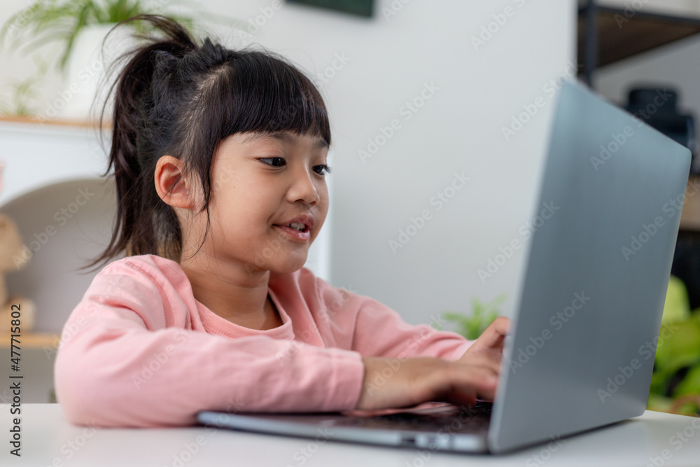 Asian girl using Laptop computer for online study homeschooling during home quarantine. homeschooling, online study, home quarantine, online learning, corona virus or education technology concept Asian girl using Laptop computer for online study homeschooling during home quarantine. homeschooling, online study, home quarantine, online learning, corona virus or education technology concept