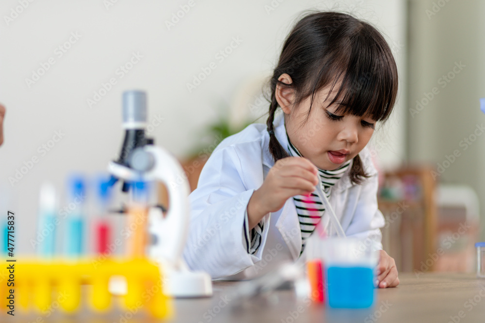 education, science, chemistry and children concept - kids or students with test tube making experiment at school laboratory education, science, chemistry and children concept - kids or students with test tube making experiment at school laboratory