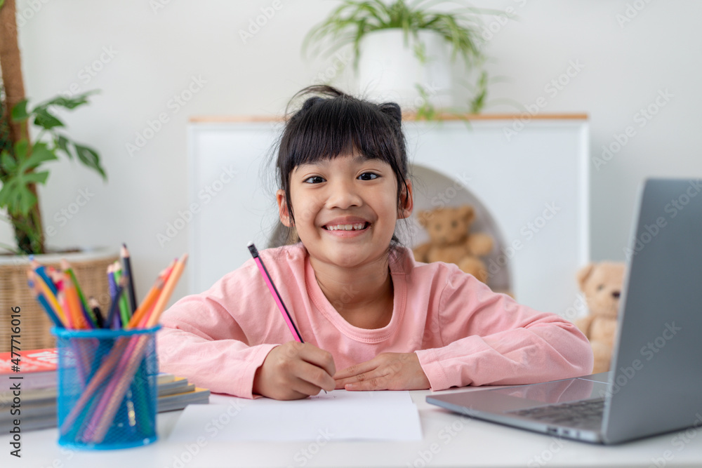 Asian girl using Laptop computer for online study homeschooling during home quarantine. homeschooling, online study, home quarantine, online learning, corona virus or education technology concept Asian girl using Laptop computer for online study homeschooling during home quarantine. homeschooling, online study, home quarantine, online learning, corona virus or education technology concept