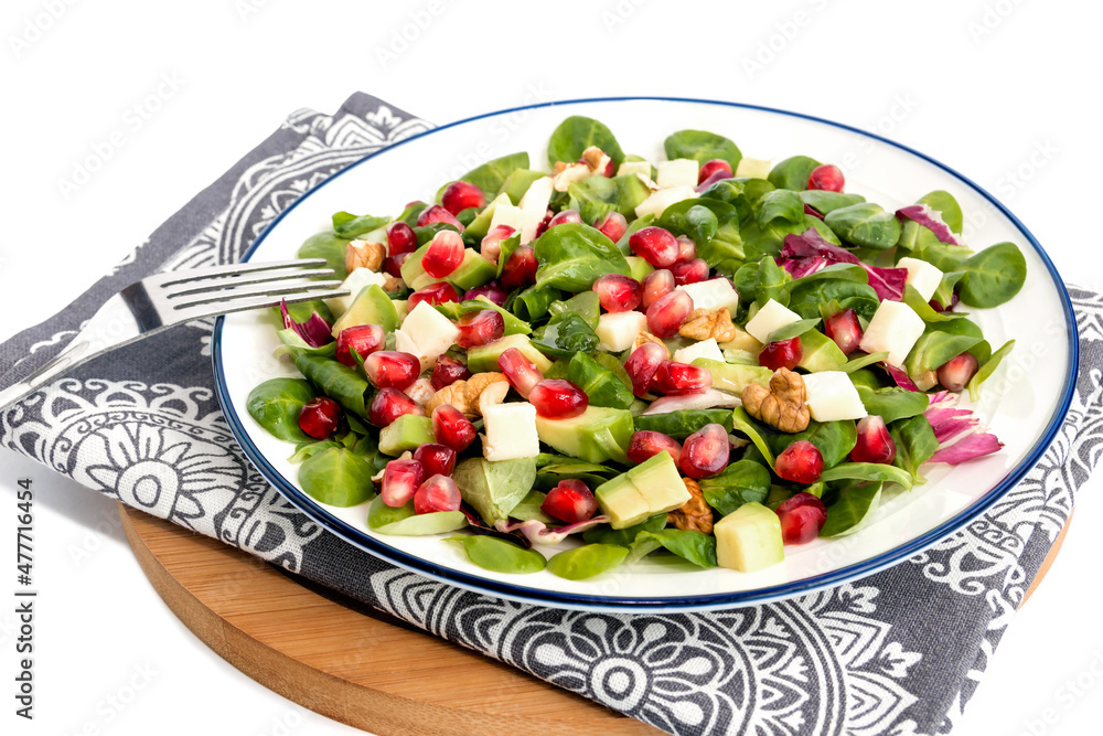 Vegetable vitamin salad with fresh young spinach leaves, mozzarella cheese, pomegranate seeds, avocado, walnuts and lemon juice. 