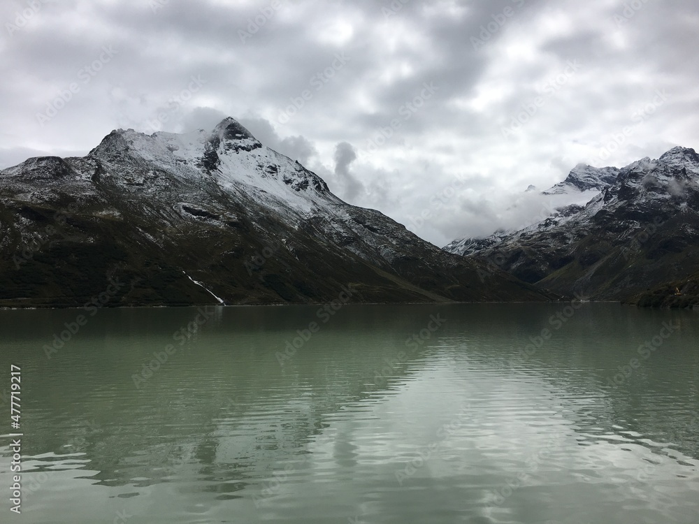 Panorama of alpine mountains covered with snow and a lake in Austria