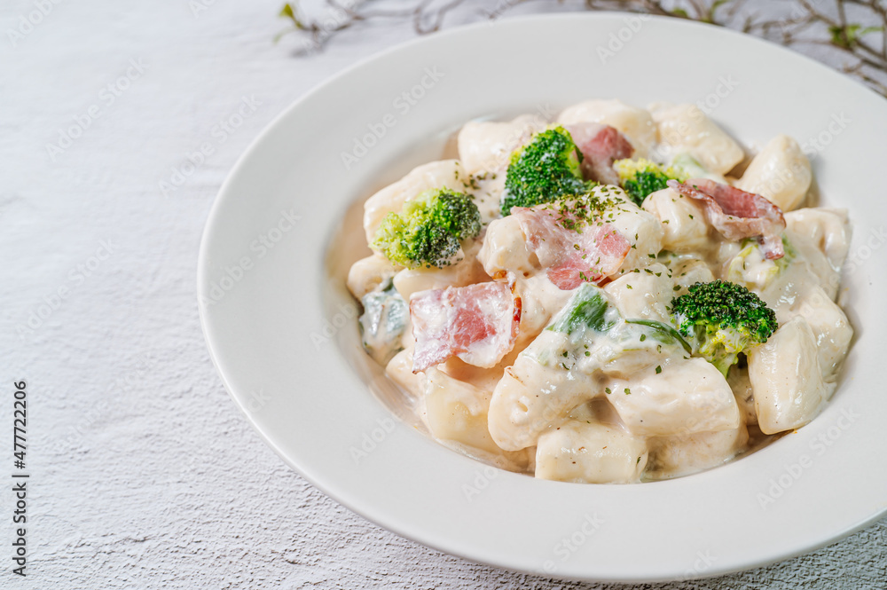 Korean food Spicy Stir-fried Carbonara tteokbokki dish on white plate Korean food Spicy Stir-fried Carbonara tteokbokki dish on white plate