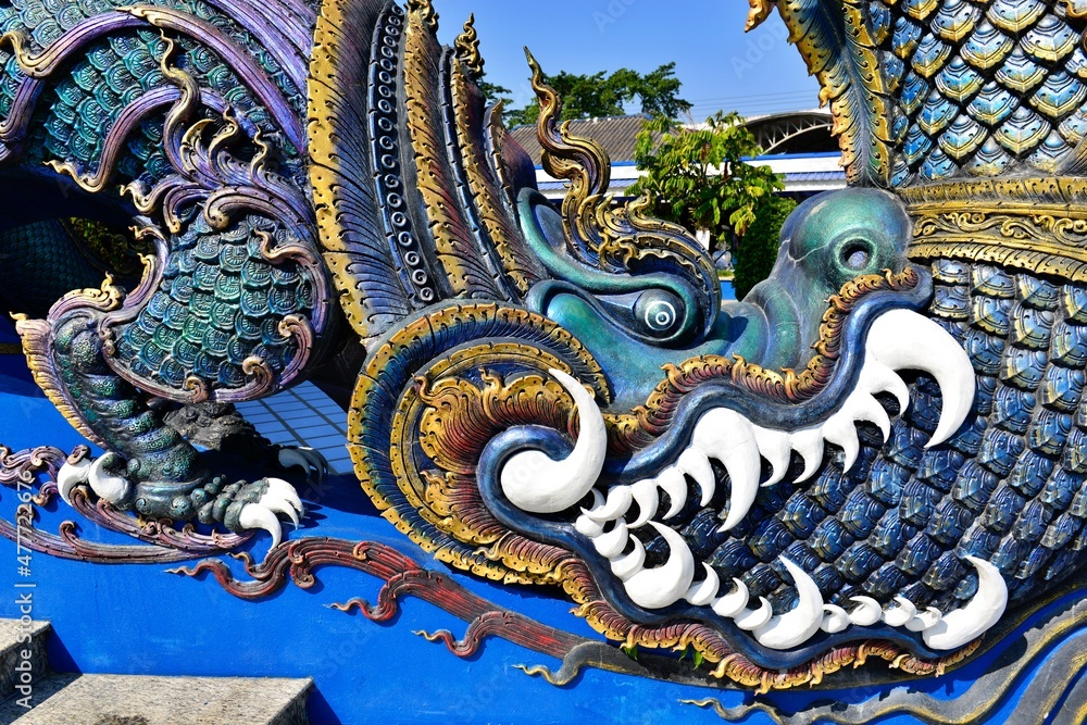 Fototapeta premium Thai sculpture on the stair Wat Rong Sua Ten (Blue temple), Chiangrai Thailand.