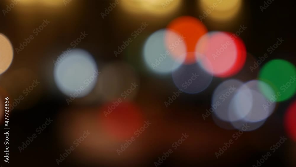 Beautiful glittering bokeh in dark blurry background at night. The round colorful bokeh shine from car lights on city street. Out of focus with blurry. Unfocused city lights. Traffic bokeh. Abstract Beautiful glittering bokeh in dark blurry background at night. The round colorful bokeh shine from car lights on city street. Out of focus with blurry. Unfocused city lights. Traffic bokeh. Abstract