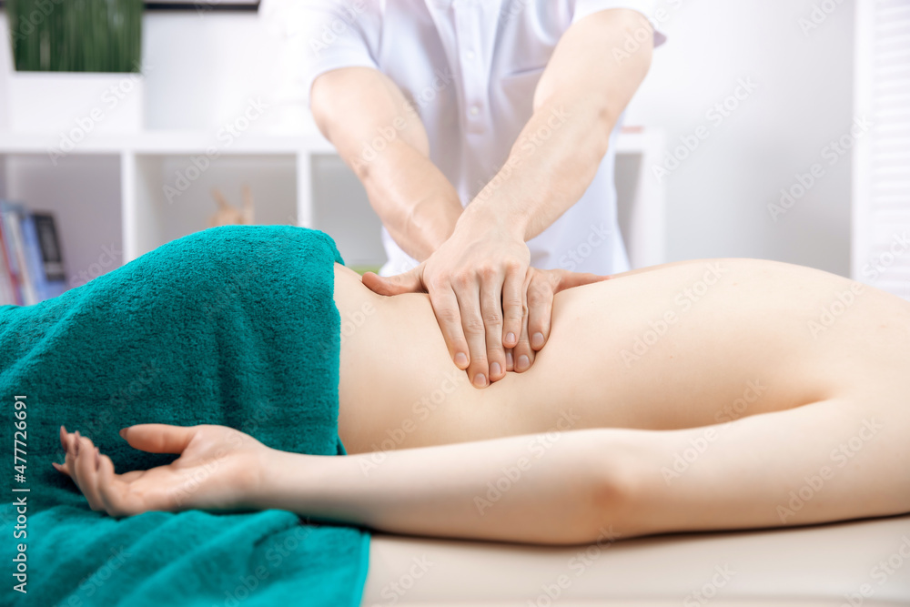 Medical massage of back young woman, closeup of hands of male doctor osteopath Medical massage of back young woman, closeup of hands of male doctor osteopath