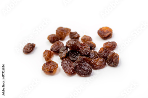 Raisins on white background, dried seedless grapes. Isolated Raisin