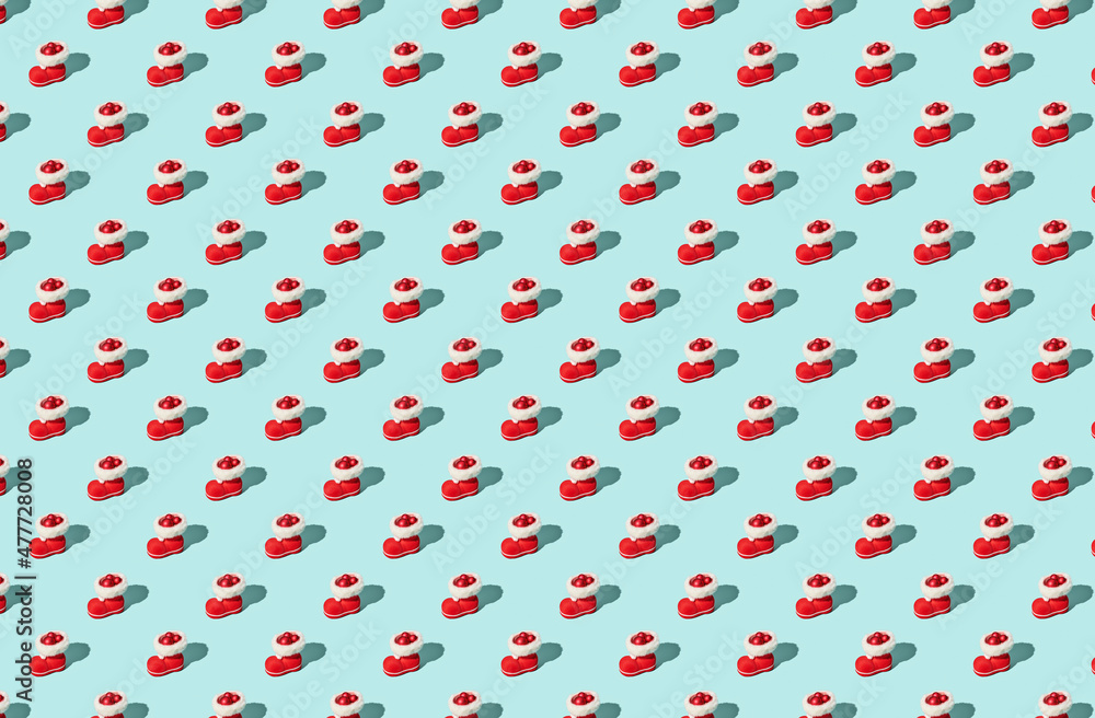 Pattern of red Santa's boot on green pastel background