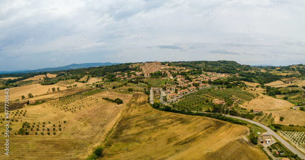 Casale Marittimo, Tuscany, Pisa region, Medieval old town with cypress tress and crops hay, city on a hill top, landscape drone aerial panorama	