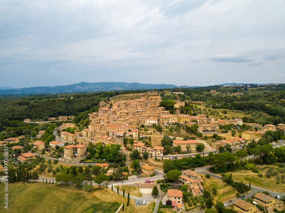 Casale Marittimo, Tuscany, Pisa region, Medieval old town with cypress tress and crops hay, city on a hill top, landscape drone aerial panorama	
