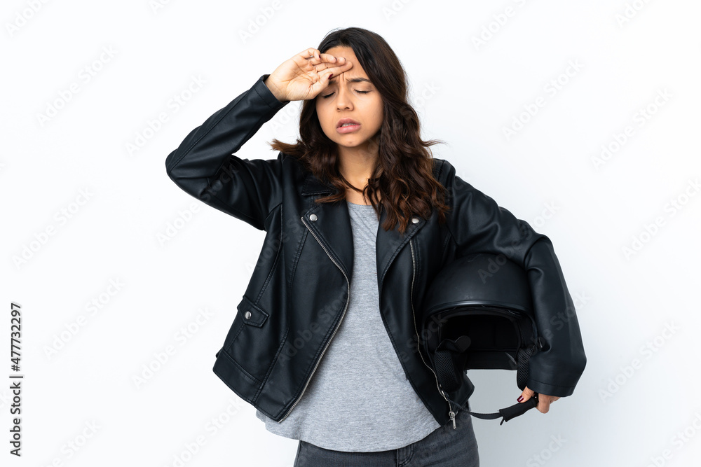Young woman holding a motorcycle helmet over isolated white background with tired and sick expression Young woman holding a motorcycle helmet over isolated white background with tired and sick expression