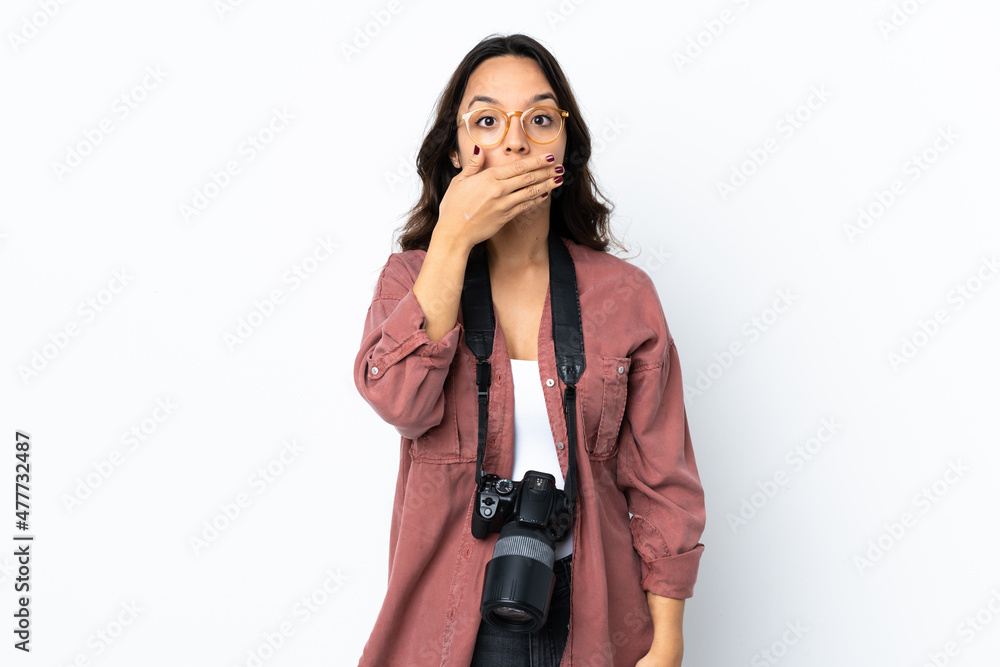 Young photographer woman over isolated white background covering mouth with hand Young photographer woman over isolated white background covering mouth with hand