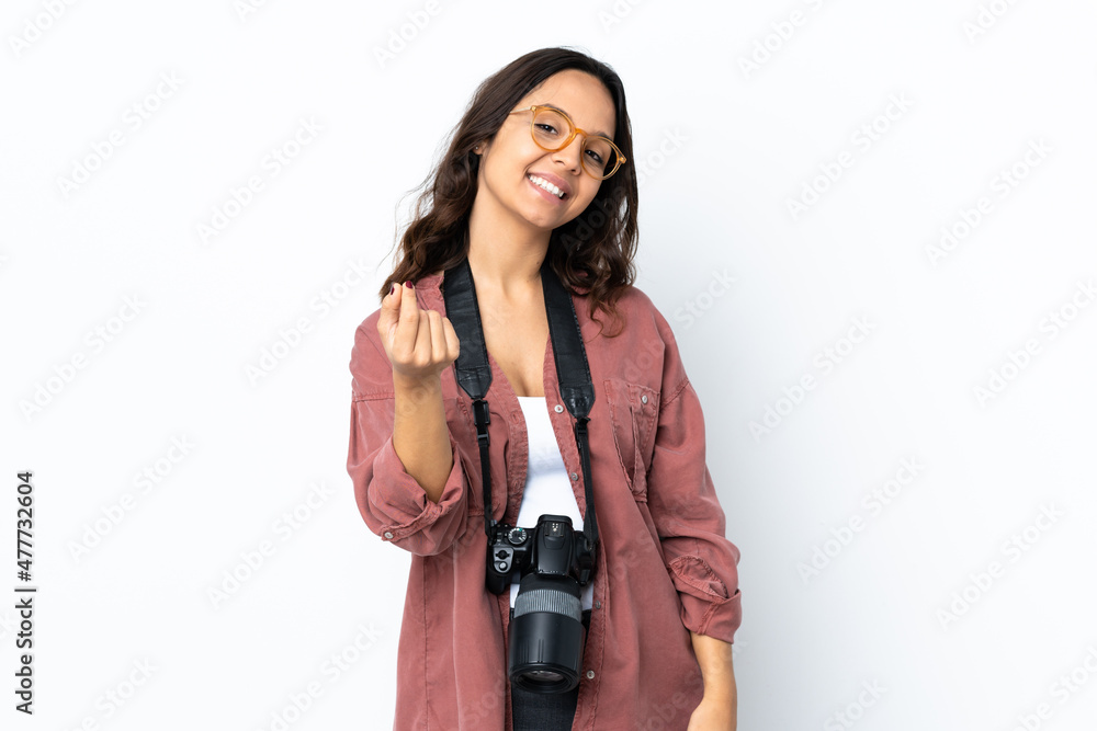 Young photographer woman over isolated white background making money gesture Young photographer woman over isolated white background making money gesture