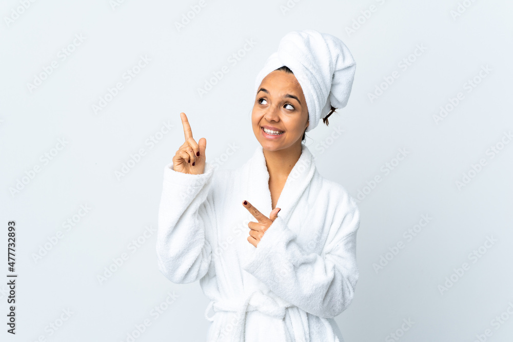 Young woman in bathrobe over isolated white background pointing with the index finger a great idea Young woman in bathrobe over isolated white background pointing with the index finger a great idea