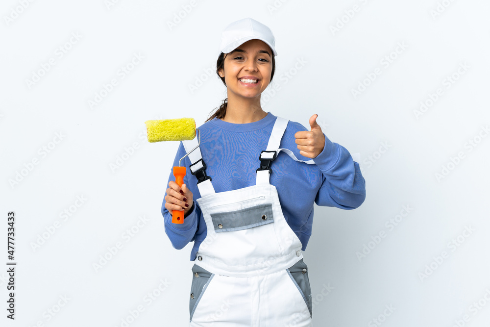 Painter woman over isolated white background holding copyspace imaginary on the palm to insert an ad and with thumbs up Painter woman over isolated white background holding copyspace imaginary on the palm to insert an ad and with thumbs up