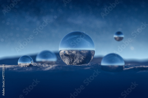 Blue reflective balls in snow against epic star sky in winter. Milky way and stars. Abstract background. 3D rendering.