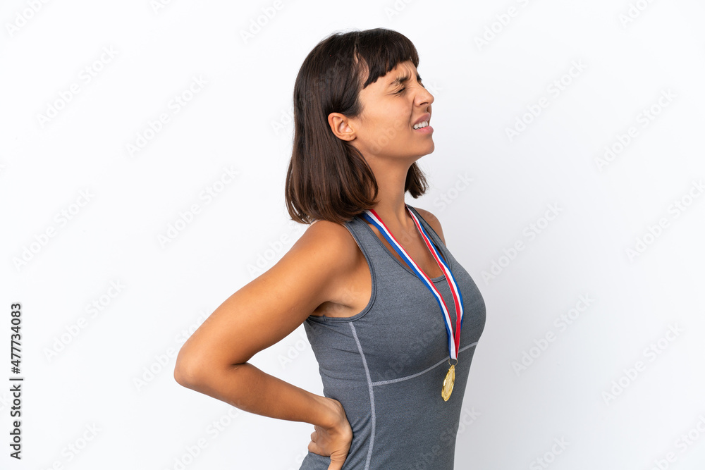 Young mixed race woman with medals isolated on white background suffering from backache for having made an effort Young mixed race woman with medals isolated on white background suffering from backache for having made an effort