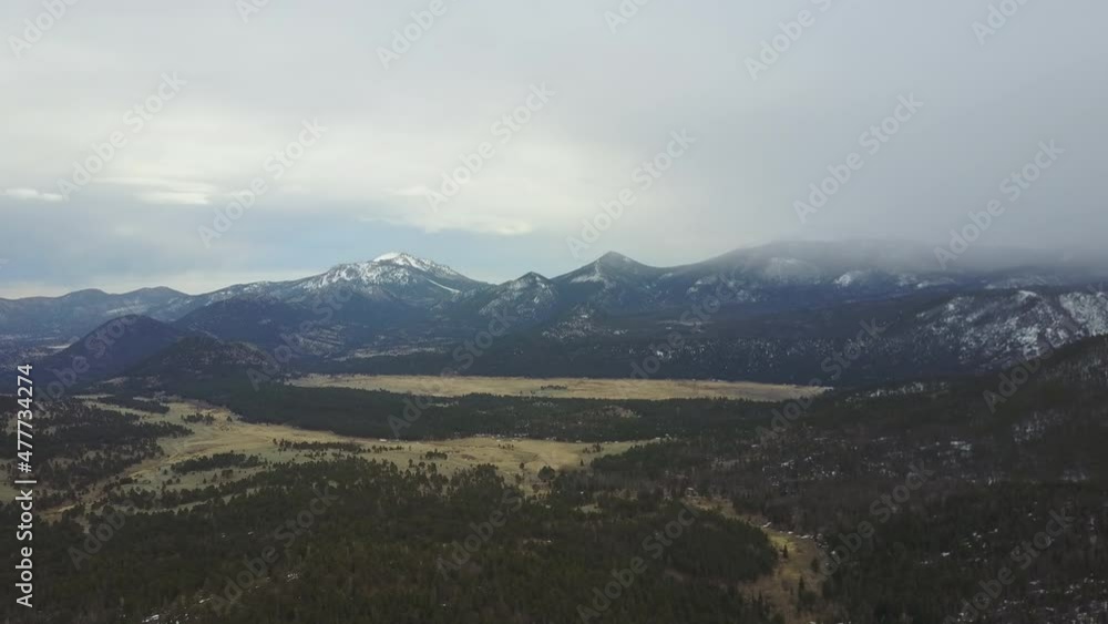 Snowy green mountains in slow drone push in Snowy green mountains in slow drone push in