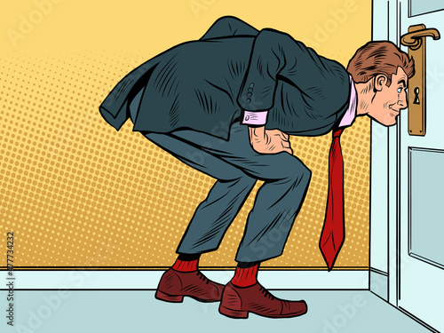 Male businessman peeping through the keyhole, secrets surveillance espionage