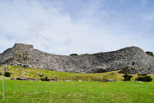 The big stone wall with grass at Nakijin castle. photo