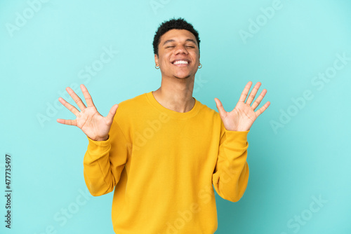 Young African American man isolated on blue background counting ten with fingers