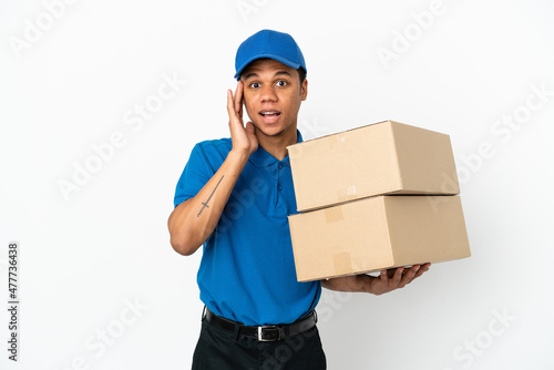 Delivery African American man isolated on white background with surprise and shocked facial expression © luismolinero