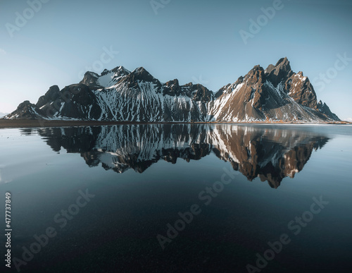 Aerial drone view of Splendid sunny day and gorgeous reflection of Vestrahorn mountaine on Stokksnes cape in Iceland. Location: Stokksnes cape, Vestrahorn Batman Mount , Iceland, Europe.