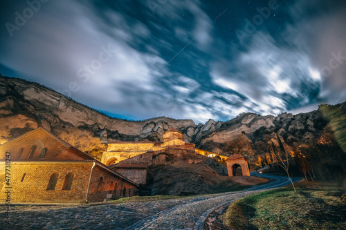 Mtskheta, Georgia. Medieval Monastic Shio-Mgvime Monastery Shiomgvime Complex Under Autumn Night Starry Sky With Glowing Stars And Real Meteoric Track Trail Over Above Famous Place.