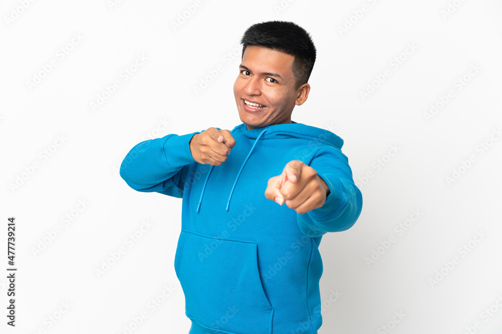 Young Ecuadorian man isolated on white background surprised and pointing front Young Ecuadorian man isolated on white background surprised and pointing front