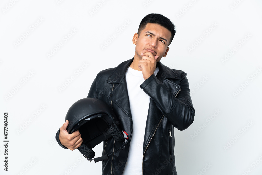 Ecudorian man with a motorcycle helmet isolated on white background and looking up Ecudorian man with a motorcycle helmet isolated on white background and looking up