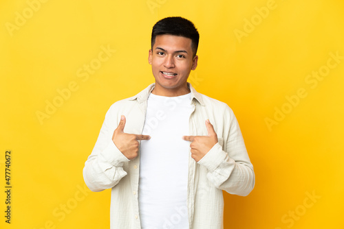 Young Ecuadorian man isolated on yellow background with surprise facial expression