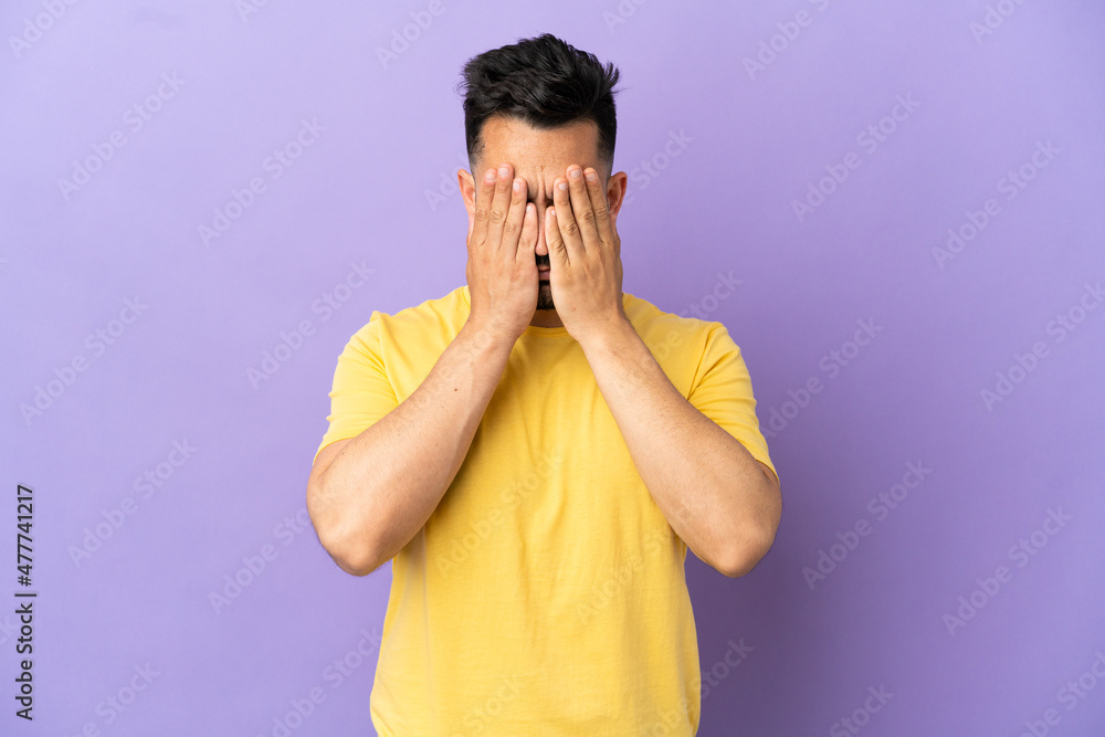 Young caucasian man isolated on purple background covering eyes by hands Young caucasian man isolated on purple background covering eyes by hands