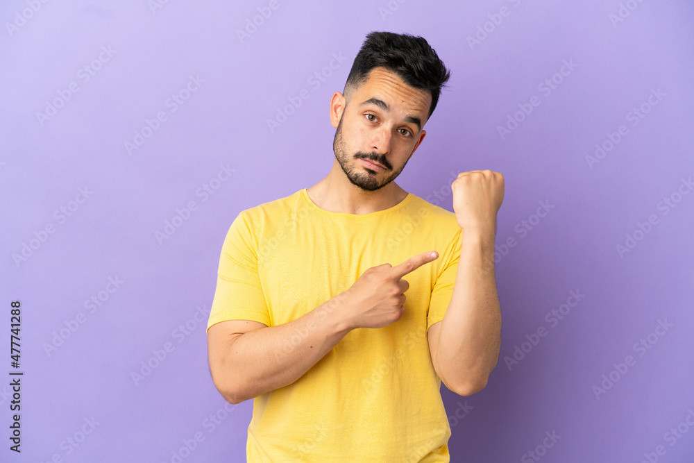 Young caucasian man isolated on purple background making the gesture of being late Young caucasian man isolated on purple background making the gesture of being late