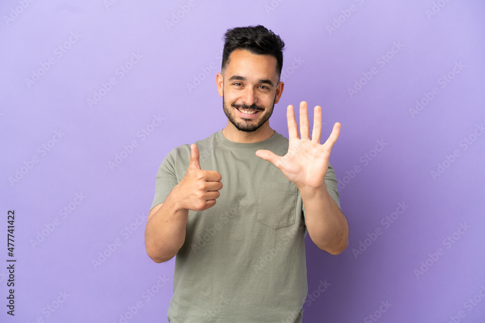 Young caucasian man isolated on purple background counting six with fingers Young caucasian man isolated on purple background counting six with fingers