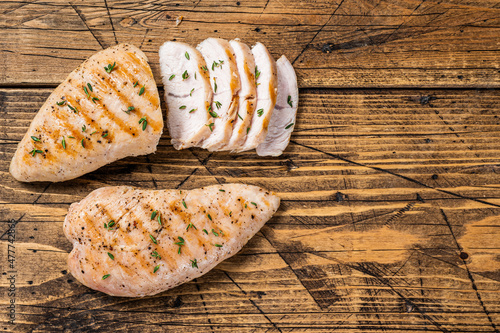 Grilled Turkey breast fillet steak. Wooden background. Top view. Copy space
