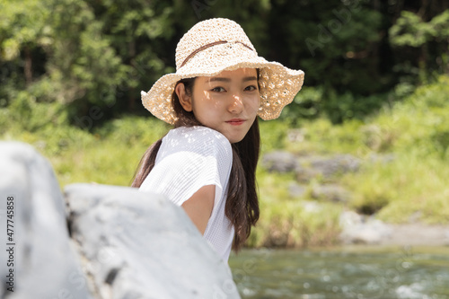 Girl on a rock in the river
