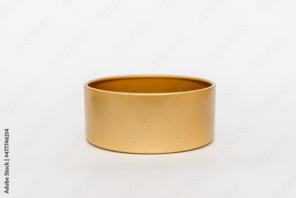Yellow golden round empty metal box on white background.Soft focus,copy space. Yellow golden round empty metal box on white background.Soft focus,copy space.