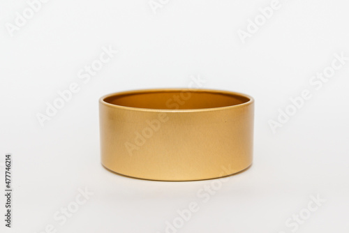 Yellow golden round empty metal box on white background.Soft focus,copy space. © ARVD73
