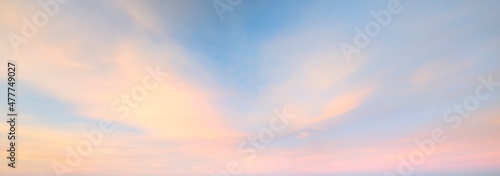 Clear blue sky with glowing pink and golden clouds after the storm. Dramatic sunset cloudscape. Concept art, meteorology, heaven, hope, peace. Graphic resources, picturesque panoramic scenery