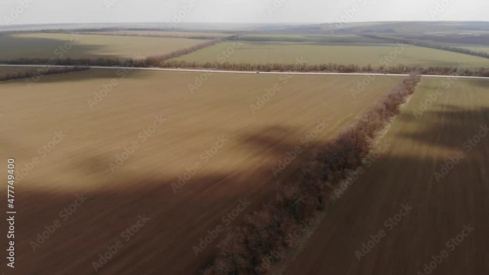 Aerial view of an agricultural field with sprayer, herbicides and pesticides at sunset. Agricultural machinery agricultural natural seasonal spring works Aerial view of an agricultural field with sprayer, herbicides and pesticides at sunset. Agricultural machinery agricultural natural seasonal spring works