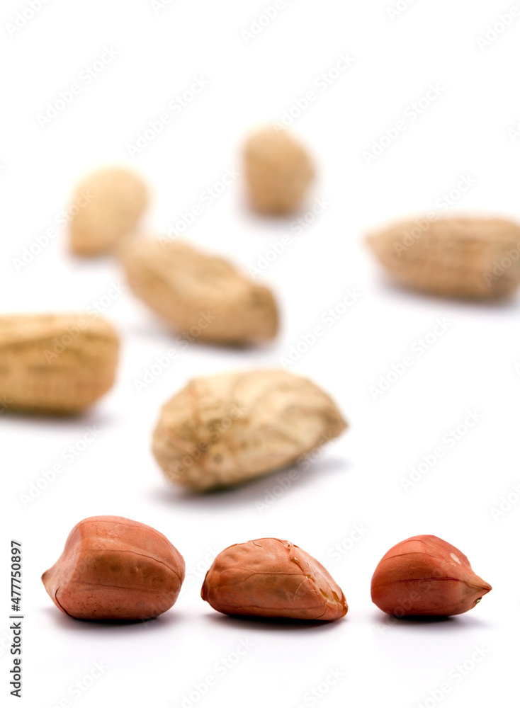 Dried peanuts in closeup on white background Dried peanuts in closeup on white background