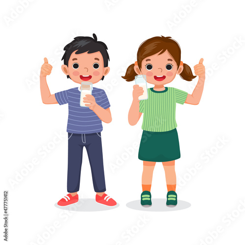 happy little boy and girl holding and showing a glass of milk giving thumb up gesture with positive facial expressions