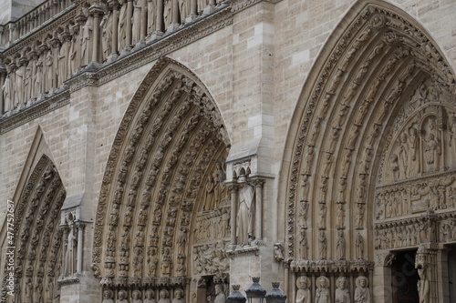 closeup of old notre dame stone intricate entrance in paris france