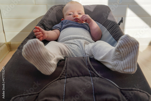 Child baby four month old lying on a chaise lounge chair. . High quality photo photo