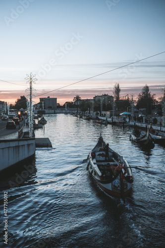 Sunset photography in Aveiro, with boats passing in the background