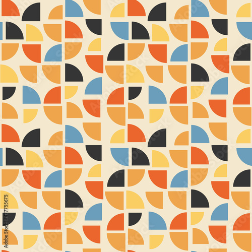 A tile made up of randomly spaced quarters of a circle. Vector with geometric quarters of different colors on a dull yellow background. Geometric decor pattern without seams.